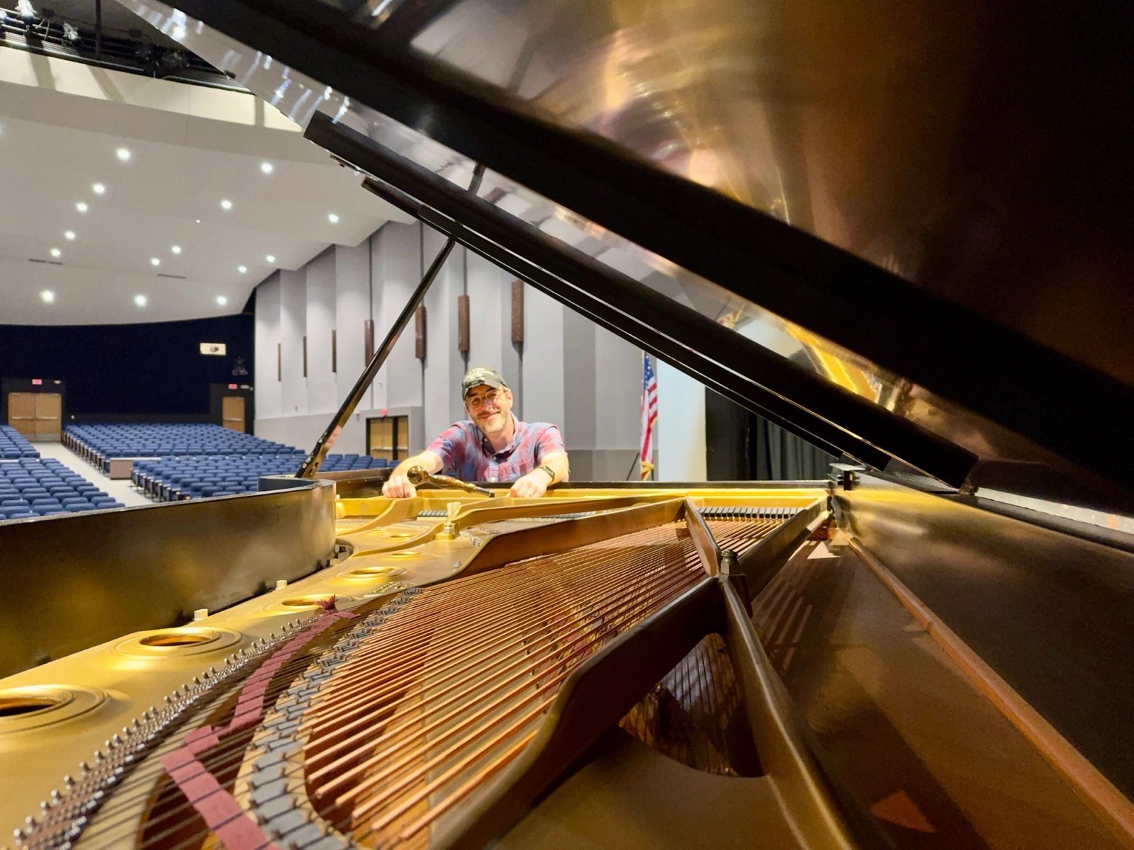 Philip Smith tuning a nine-foot Steinway concert grand at the Klett Performing Arts Center